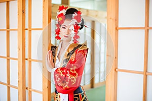 Cosplay. beautiful, modest geisha in a red kimono