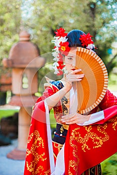 Cosplay. beautiful, modest geisha in a red kimono