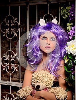 Cosplay girl in purple wig with soft toy