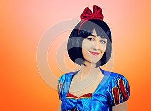 Cosplay of Snow White on the pink-orange background. Artistic processing