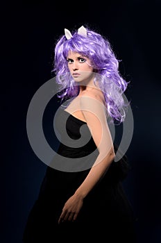 Cosplay woman in black dress and purple wig