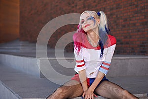 Cosplayer girl with in Harley Quinn costume photo