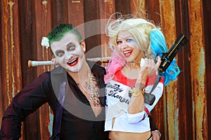 Cosplayer girl in Harley Quinn costume and man in Joker costume