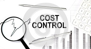 COST CONTROL document with pen,graph and magnifier,calculator,business concept