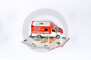 Cost of health care: Ambulance car with Euro money