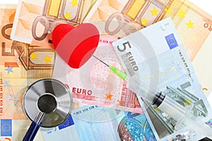 Cost of health care: stethoscope red heart on euro money