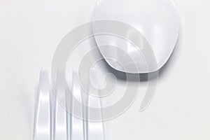 Cost-up plastic spoon and fork isolated on white background.