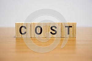 Cost Word on Wooden Block
