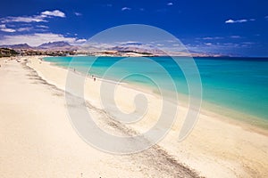 Costa Calma sandy beach with vulcanic mountains on Jandia peninsula, Fuerteventura island, Canary Islands, Spain. photo