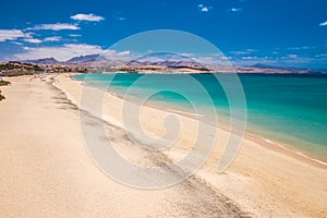 Costa Calma sandy beach with vulcanic mountains on Jandia peninsula, Fuerteventura island, Canary Islands, Spain. photo