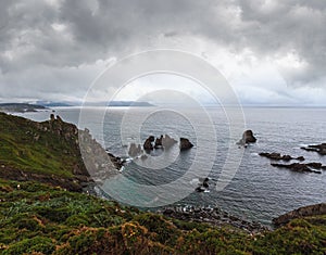 Costa de Loiba sunset bad weather before thunderstorm landscape with rock formations near shore (Galicia, Spain photo