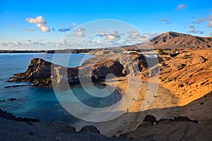 Costa de Papagayo on a sunny evening. The mountain range Los Ajaches in the background. Lanzarote, Spain