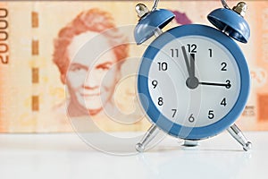 Costa Rica banknote, twenty thousand Colones, alarm clock set to five to twelve, economic and business concept