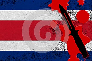 Costa Rica flag and black tactical knife in red blood. Concept for terror attack or military operations with lethal outcome