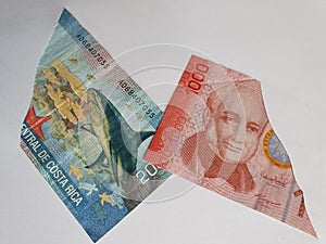 Costa Rican banknotes on the broken sheet of paper