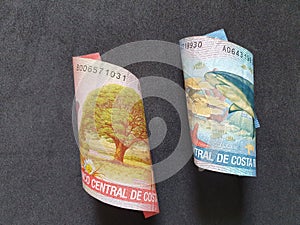 Costa Rican banknotes of different denominations and black background