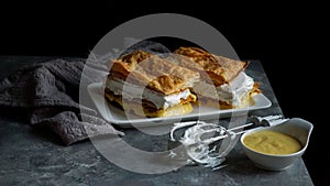 Costrada or millefeuille with - traditional dessert made with puff pastry, cream and custard. Milhojas de merengue y crema, photo
