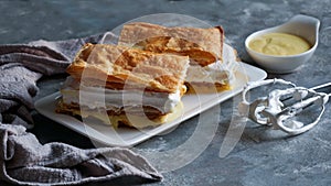 Costrada or millefeuille with - traditional dessert made with puff pastry, cream and custard. Milhojas de merengue y crema, photo