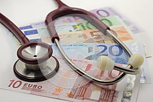 Costs and revenues in the health sector with euro banknote