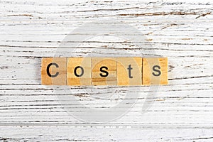 COSTS word made with wooden blocks concept