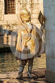 Costumed person in Venetian mask