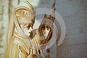 Costumed person in Venetian mask