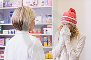 Costumer blowing in front of pharmacist
