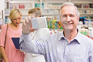 Costumer holding up medicine box photo