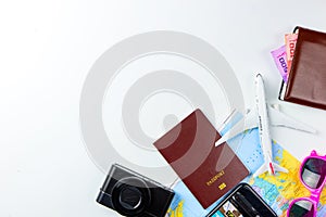Costumes concept for summer vacation trip. Passports, luggage, map, smartphone,sun glasses,camera, note pad, jean on white