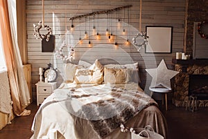Cosy bedroom with eco decor. Wood and nature concept in interior of room. Scandinavian interior, real photo. Hygge decoration