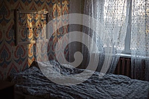 Cosy bedroom with sunlight shadows.