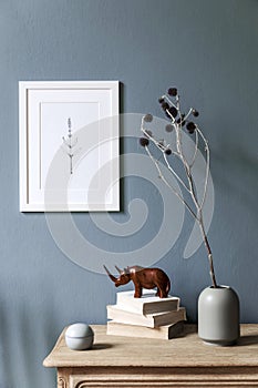 Cosy, boho living room interior with white poster frame on the wall.