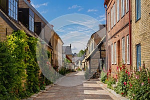 A cosy cobblestone street with half-timbered houses in the old parts of the medieval university city of Lund, Sweden