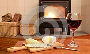 Cosy evening by woodburner fire with wine and cheese