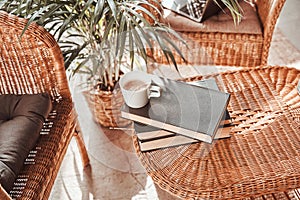 Cosy hotel room with chairs and table with books and coffee cup