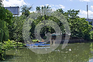 Cosy nook for  relaxation with wooden pontoon and boats in lake Ariana, park  Borisova gradina