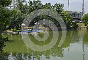 Cosy nook for summer relaxation with wooden pontoon and boat in lake Ariana, park Borisova gradina