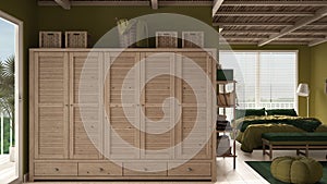 Cosy wooden peaceful bedroom in green tones, double bed with pillows and blankets, ceramic tiles floor, carpet, pouf, window,