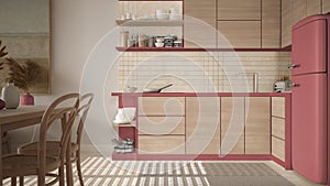 Cosy wooden sustainable dining room and kitchen in red tones with ceramic tiles. Cabinets, shelves, pan and appliances, table with