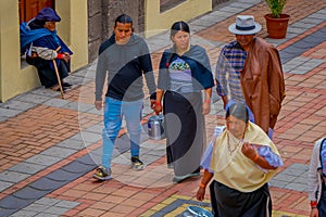 COTACACHI, ECUADOR, NOVEMBER 06, 2018: Unidentified people walking in the sidewak, of the city of Cotacachi