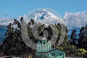 Cotopaxi volcano over the San Jaloma Church, Andes photo