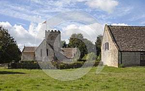 Cotswold church and Tithe Barn at Guiting Power, Gloucestershire, England