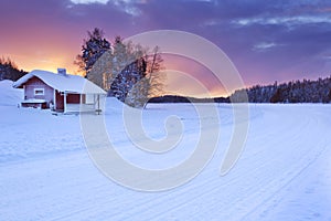 Cottage along a frozen lake in winter, Levi, Finnish Lapland