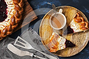 Cottage cheese cake with berry jam and coffee on a dark blue background. Top view, flat lying