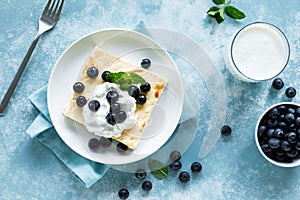 Cottage cheese cheesecake slice with fresh blueberry, top down view