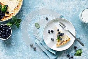 Cottage cheese cheesecake slice with fresh blueberry, top down view