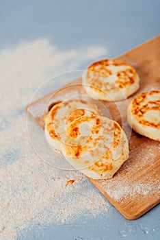 Cottage cheese cheesecakes on a wooden board