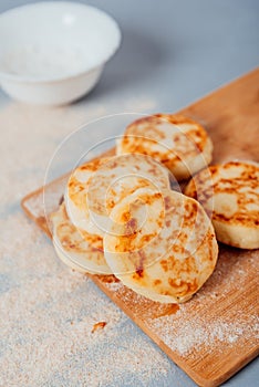 Cottage cheese cheesecakes on a wooden board