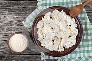 Cottage cheese on clay dish with wooden spoon