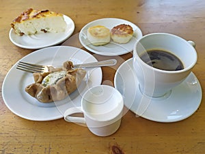 Cottage cheese dessert pastry with coffe and milk on table photo